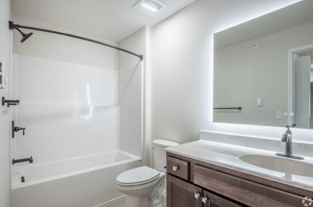 Modern bathroom with backlit mirror