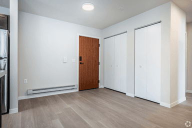 Open concept living area with modern finishes and in-unit laundry