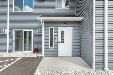 The Arnie Apartments covered parking and entrance
